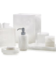 White onyx marble bathroom accessories from Labrazel including a soap dispenser, tray, and containers on a white background at Spacio retail store in Mumbai