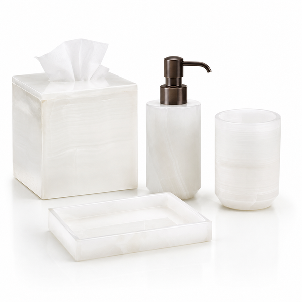 White onyx marble bathroom accessories from Labrazel including a soap dispenser, tray, tissue box, and containers on a white background at Spacio retail store in Mumbai