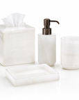 White onyx marble bathroom accessories from Labrazel including a soap dispenser, tray, tissue box, and containers on a white background at Spacio retail store in Mumbai