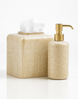 Set of beige textured woven gold bathroom accessories set from Labrazel including a tissue box and soap dispenser white background at Spacio retail store in India