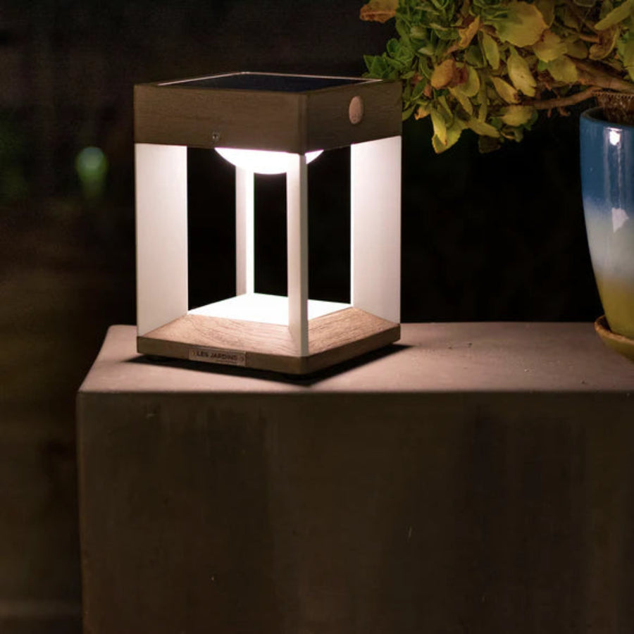 Hexagonal wooden solar lamp on a surface with a dark background