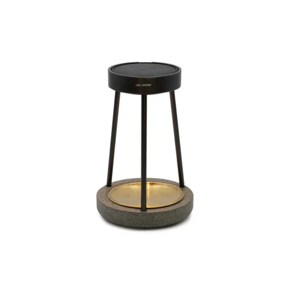 Modern outdoor solar table lamp with black metal stand and textured base on a white background