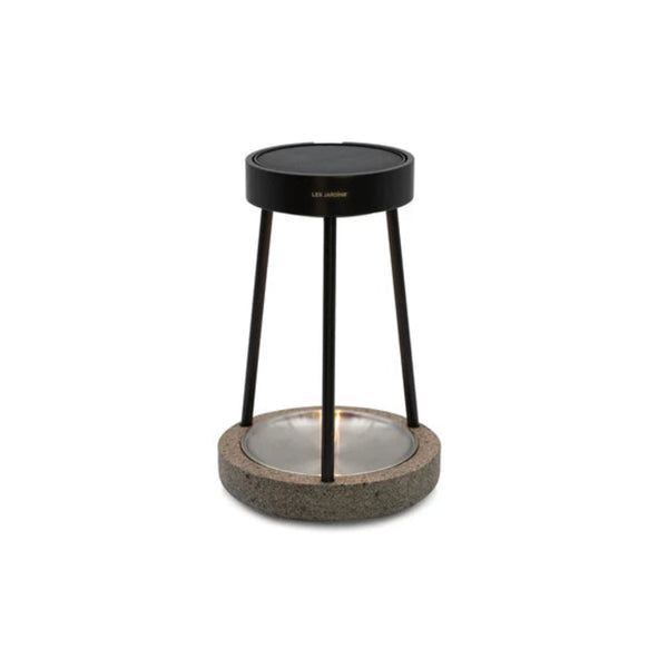 Decorative solar table lamp with black metal stand and textured base on a white background by Les Jardins available at Spacio retail stores in Mumbai & Kolkata.  