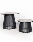 Two modern outdoor side tables with black metal legs and pinkish-brown circular tops on a white background and solar lighting from Les Jardins, available at Spacio retail stores in Mumbai & Kolkata.