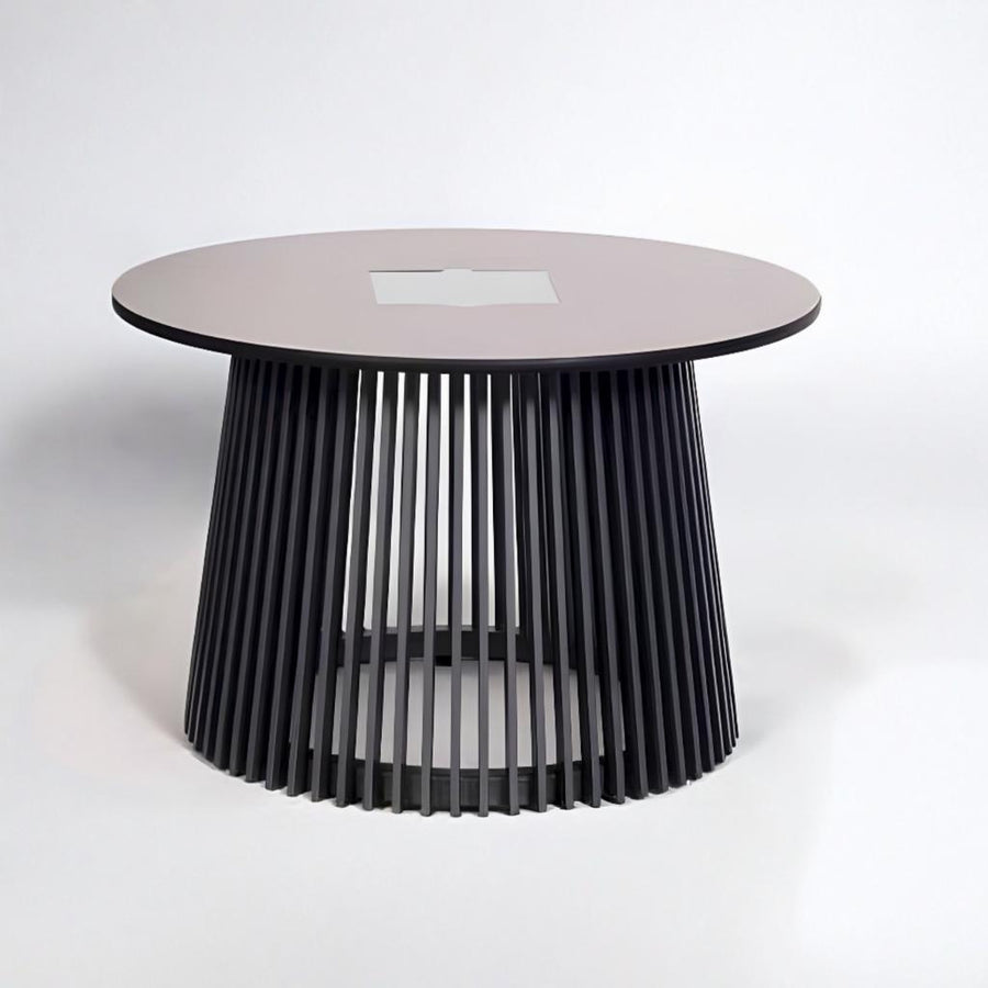 Modern round table with a black ribbed base and pinkish top on a white background with solar lighting from Les Jardins available at Spacio retail stores in Mumbai & Kolkata. 