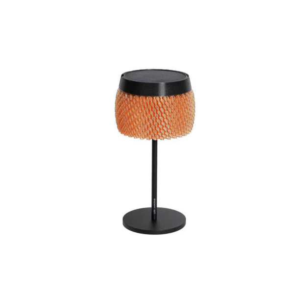 Small round solar table with orange woven top and black base on a white background by Les Jardins available at Spacio retail stores in Mumbai & Kolkata.  
