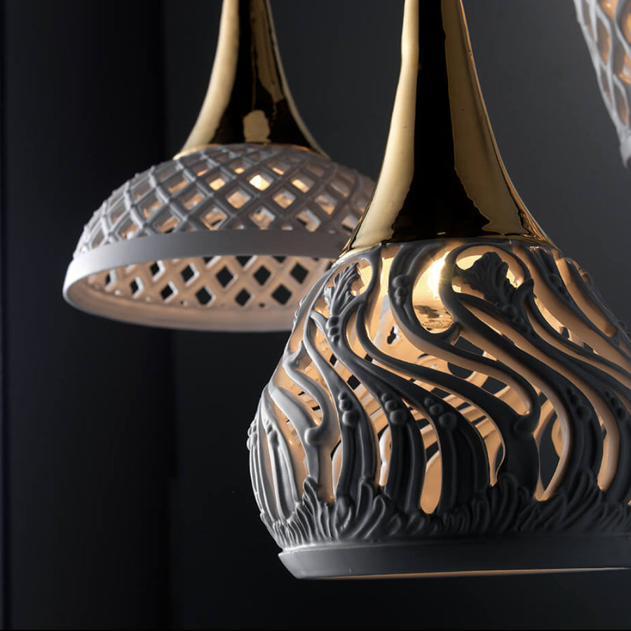 Decorative ceramic pendant lamp with intricate design on a black background
