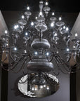 Large chandelier with multiple lights in a dark room