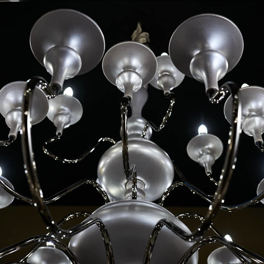 Chandelier with multiple light bulbs against a dark background