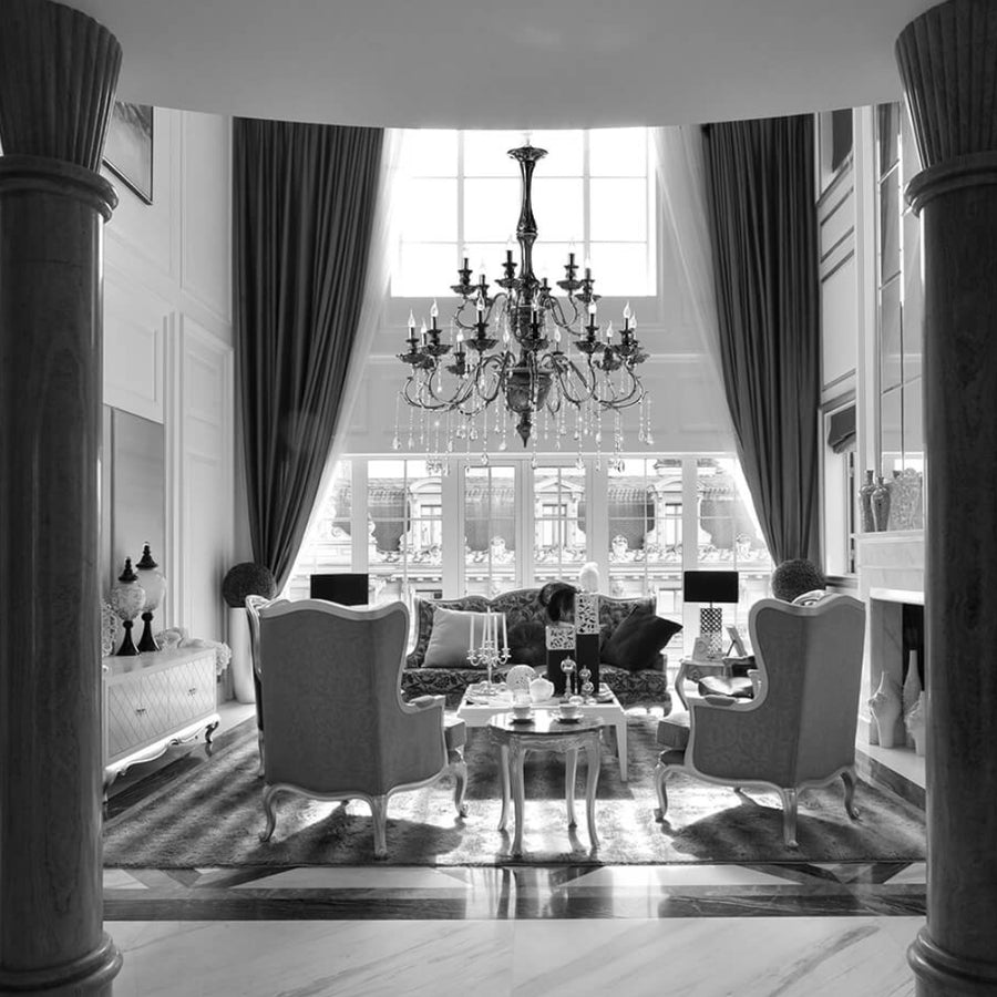 Luxurious living room with a black Italian ceramic chandelier, sofa, and decorative items from Lorenzon available at Spacio in India. 