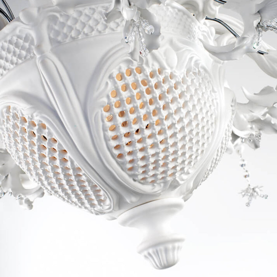 Close-up of a decorative white ceramic light fixture with intricate details