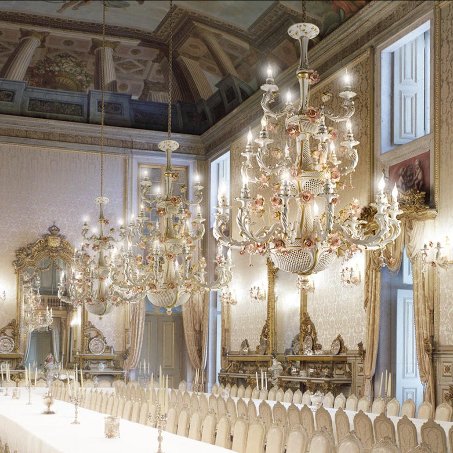 Opulent dining room with multiple Italian ceramic chandeliers and ornate decor