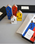 A set of ML City Opening Pop (4pc set) childhood-themed wooden houses in vibrant pop colours, neatly stored in a box, by Madlab.