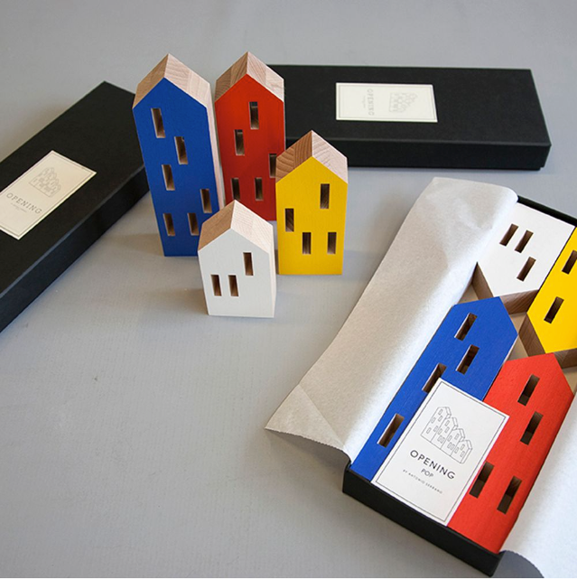 A set of ML City Opening Pop (4pc set) childhood-themed wooden houses in vibrant pop colours, neatly stored in a box, by Madlab.