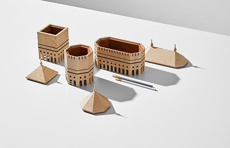 A set of Madlab's ML Utopia Collection Square Box handmade wooden buildings and a pen on a white surface.