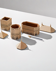 A set of Madlab's ML Utopia Collection Square Box handmade wooden buildings and a pen on a white surface.