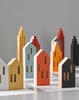 A ML City Opening Pop (4pc set) chess board with wooden buildings and pop of color reminiscent of childhood memories, by Madlab.