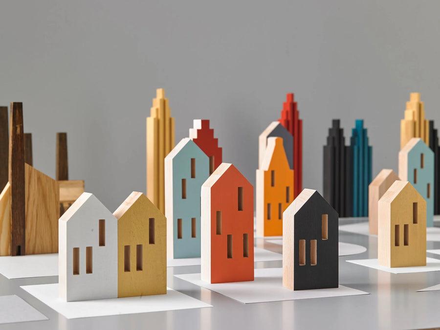 A ML City Opening Pop (4pc set) chess board with wooden buildings and pop of color reminiscent of childhood memories, by Madlab.