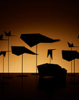 Silhouettes of ML Animal Mood Birds (5pc set) and a car in front of a dark background by Madlab.