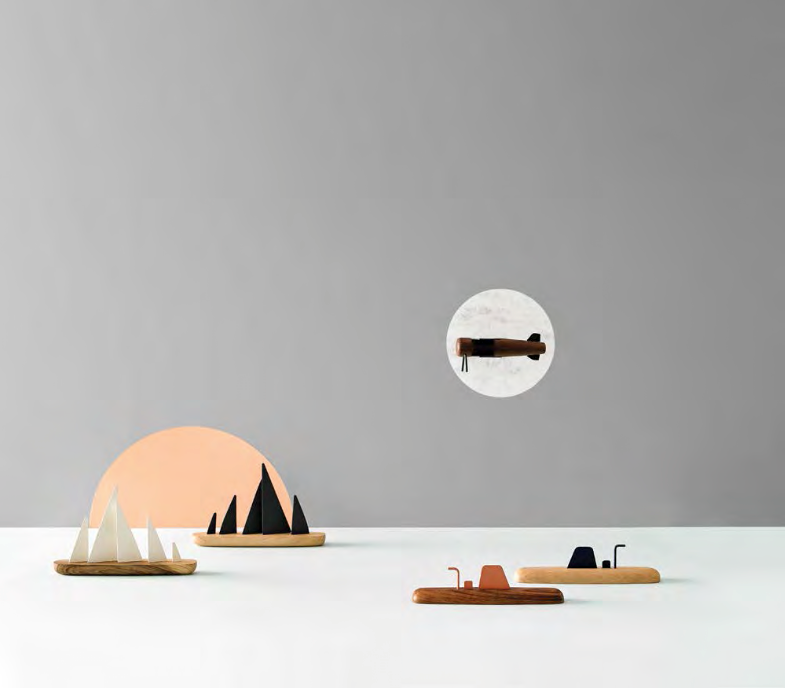 A group of ML Motor Mood Boat wooden figurines by Madlab on a white table.