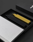 A ML Skyline Collection Black & Gold (2pc set) box with a yellow pen by Madlab.