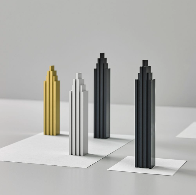 A set of ML Skyline Collection Black & Gold (2pc set) lego towers resembling buildings on a white table, produced by Madlab.