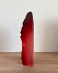 Side look of Maleras Crystal Batzeba Red Masq Sculpture on a wood console for modern interiors available at Spacio India from Sculpture and Art Objects Collection of Crystal Sculptures.