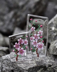 Maleras Crystal Sculpture Cherry Blossom Large with other Small sculpture on a Grey stones outdoor back ground available at Spacio India from the Sculptures and Art Objects Collection.