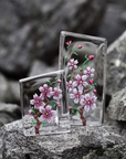 Maleras Crystal Sculpture Cherry Blossom Small with other Large sculpture on a Grey stones outdoor back ground available at Spacio India from the Sculptures and Art Objects Collection.