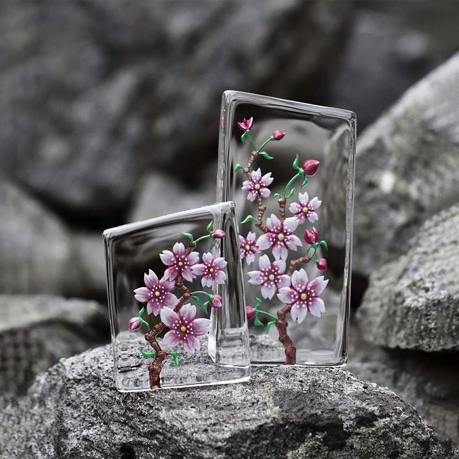 Maleras Crystal Sculpture Cherry Blossom Small with other Large sculpture on a Grey stones outdoor back ground available at Spacio India from the Sculptures and Art Objects Collection.