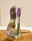 Side look of Maleras Crystal Sculpture Tulip Purple Small on a wooden table top, available at Spacio India from the Sculptures and Art Objects Collection