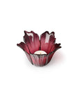 Red glass candle holder on a white background