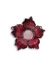 Red glass flower-shaped candle holder on a white background