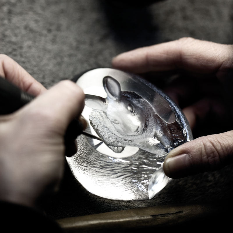 Maleras craftsmen in Sweden engraving a Maleras crystal sculpture in their factory