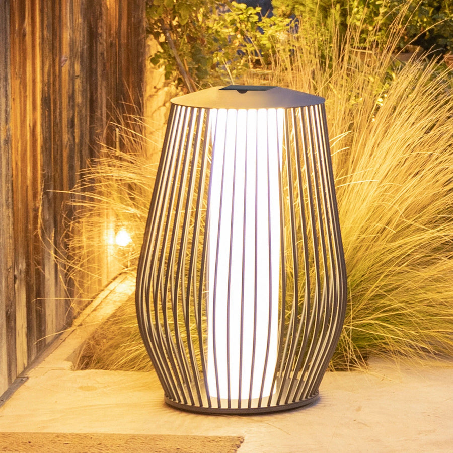 Decorative outdoor solar lamp with a wicker-like design on a patio by Les Jardins available at Spacio retail stores in Mumbai & Kolkata. 