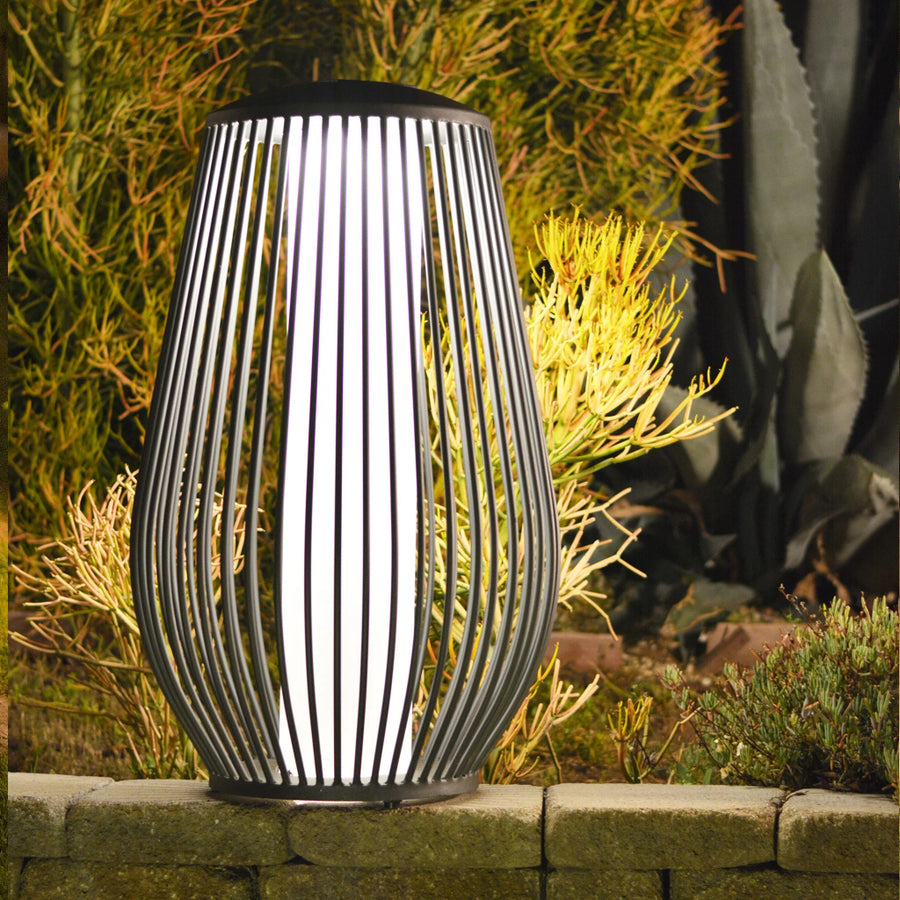 Decorative outdoor solar lamp with striped design on a stone ledge by Les Jardins available at Spacio retail stores in Mumbai & Kolkata. 