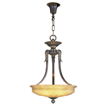 Decorative pendant light with a yellow alabaster shade on a white background