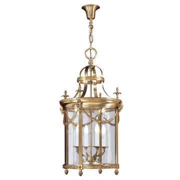 Decorative brass pendant light with clear glass on a white background