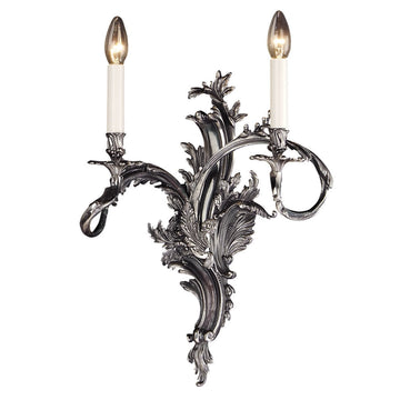 Decorative wall sconce with intricate design and two lit candles on a white background