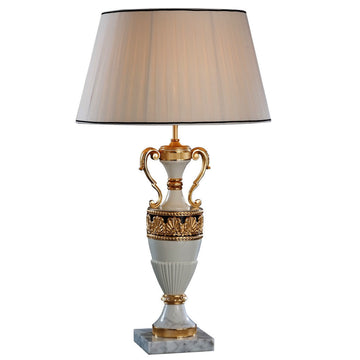 Decorative table lamp with gold accents on a white background made of bronze, alabaster by Mariner, available at Spacio in India. 