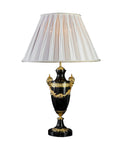 Decorative table lamp with a black base and gold accents on a white background