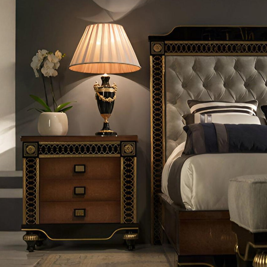 Decorative nightstand with lamp and bed in a bedroom setting