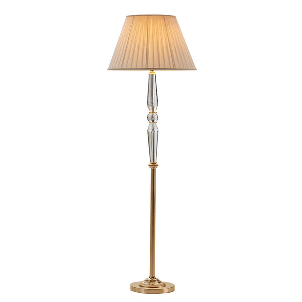 Floor lamp with a pleated beige shade on a white background