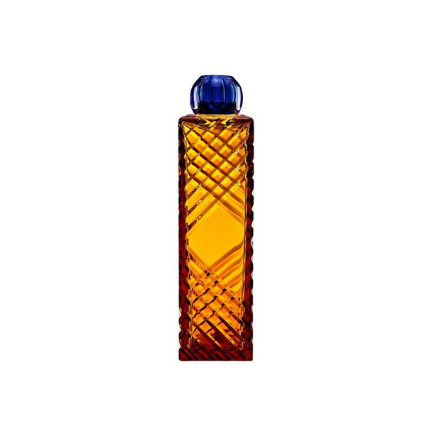 Amber crystal vase with a blue crystal cap on a white background. 