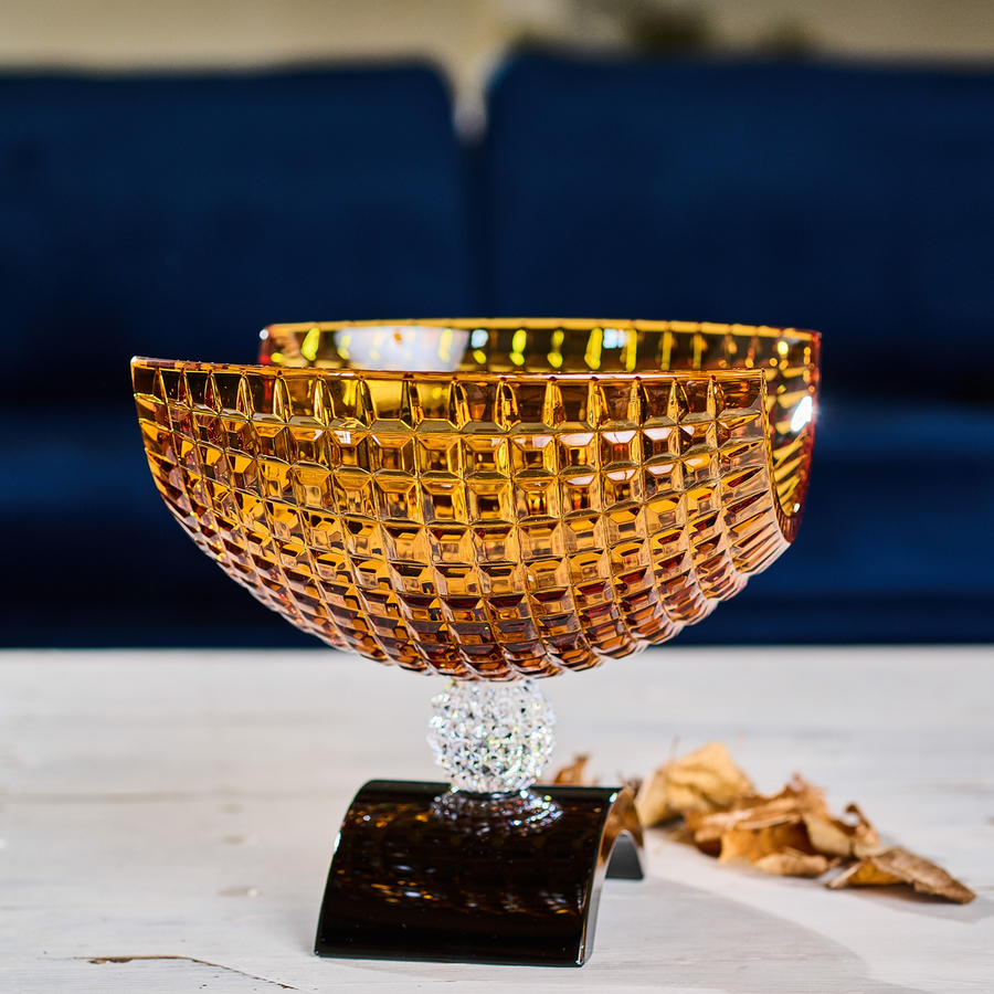 Side look of Mario Cioni Crystal Amber Bowl with Black base on a a wooden table available at Spacio India for luxury home decor accessories collection of Bowls & Centerpieces.