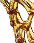 A close up of a yellow Mario Cioni Crystal Arabesque Vase Amber.