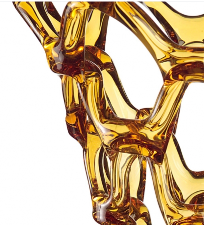 A close up of a yellow Mario Cioni Crystal Arabesque Vase Amber.