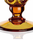 A stunning Mario Cioni Crystal Arabesque Vase Amber made of orange and yellow glass stands elegantly against a clean white background. This crystal ware piece beautifully showcases the exquisite craftsmanship of Mario Cioni.