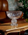 Clear crystal bowl on a wooden table with a blurred background