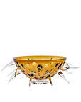 Decorative amber crystal bowl with decorative legs on a white background